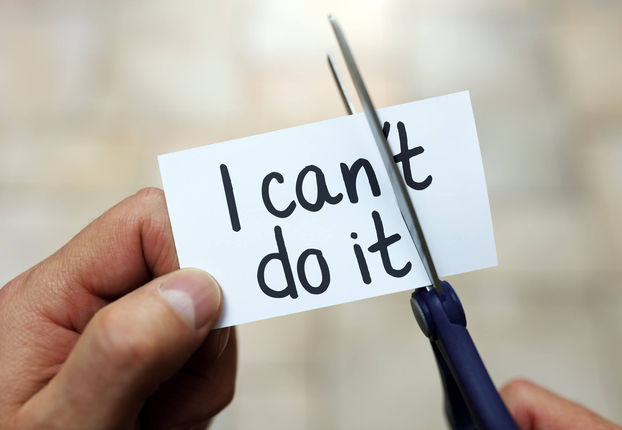 "I cant do it" sign being cut to "I can do it" sign