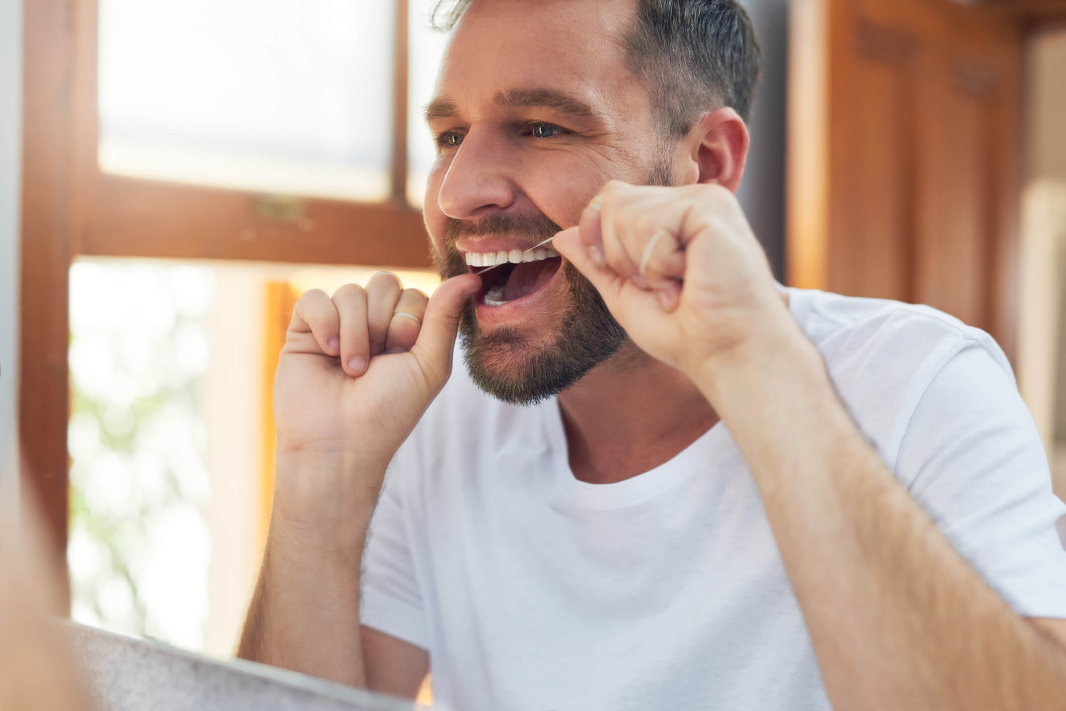 smiling man flossing