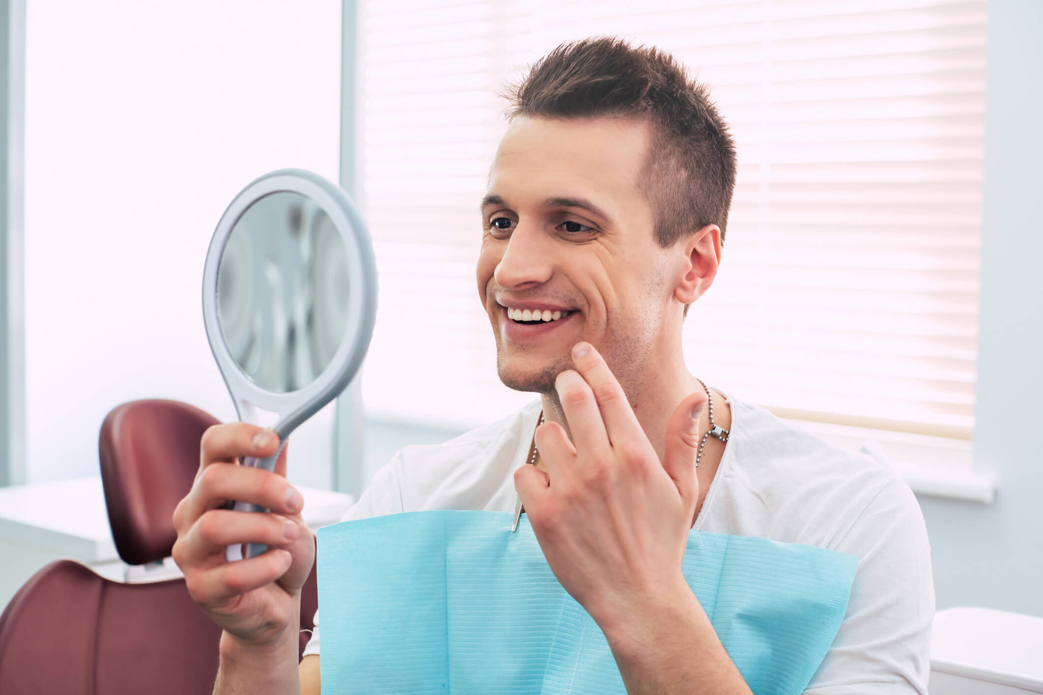 smiling man looking in mirror