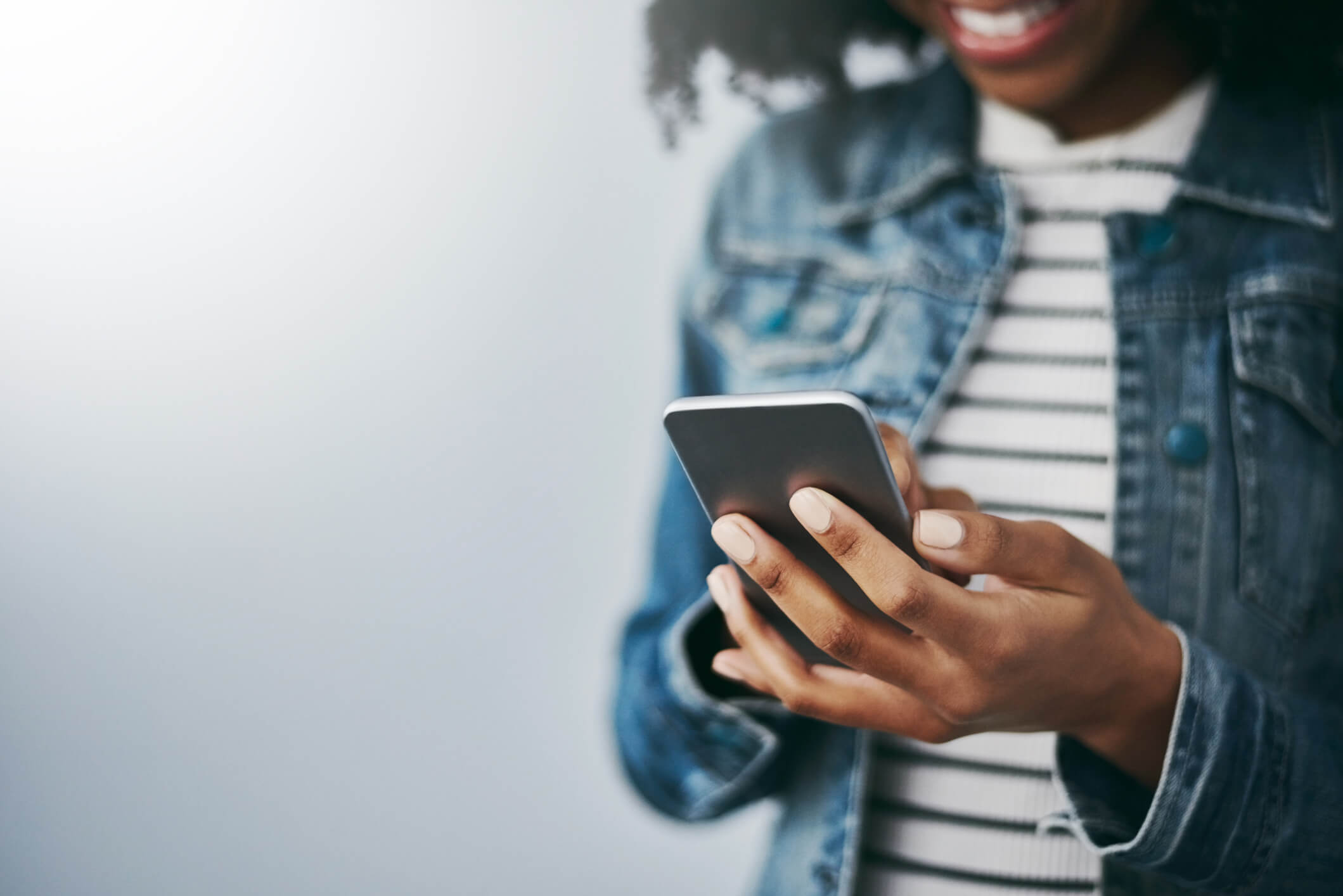 smiling woman holding cell phone