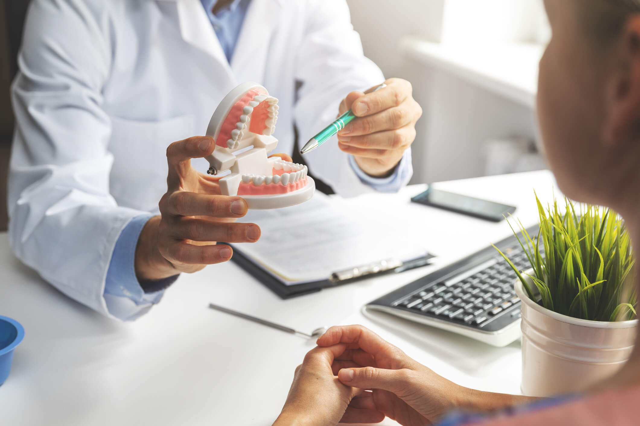 dentist pointing to dental diagram