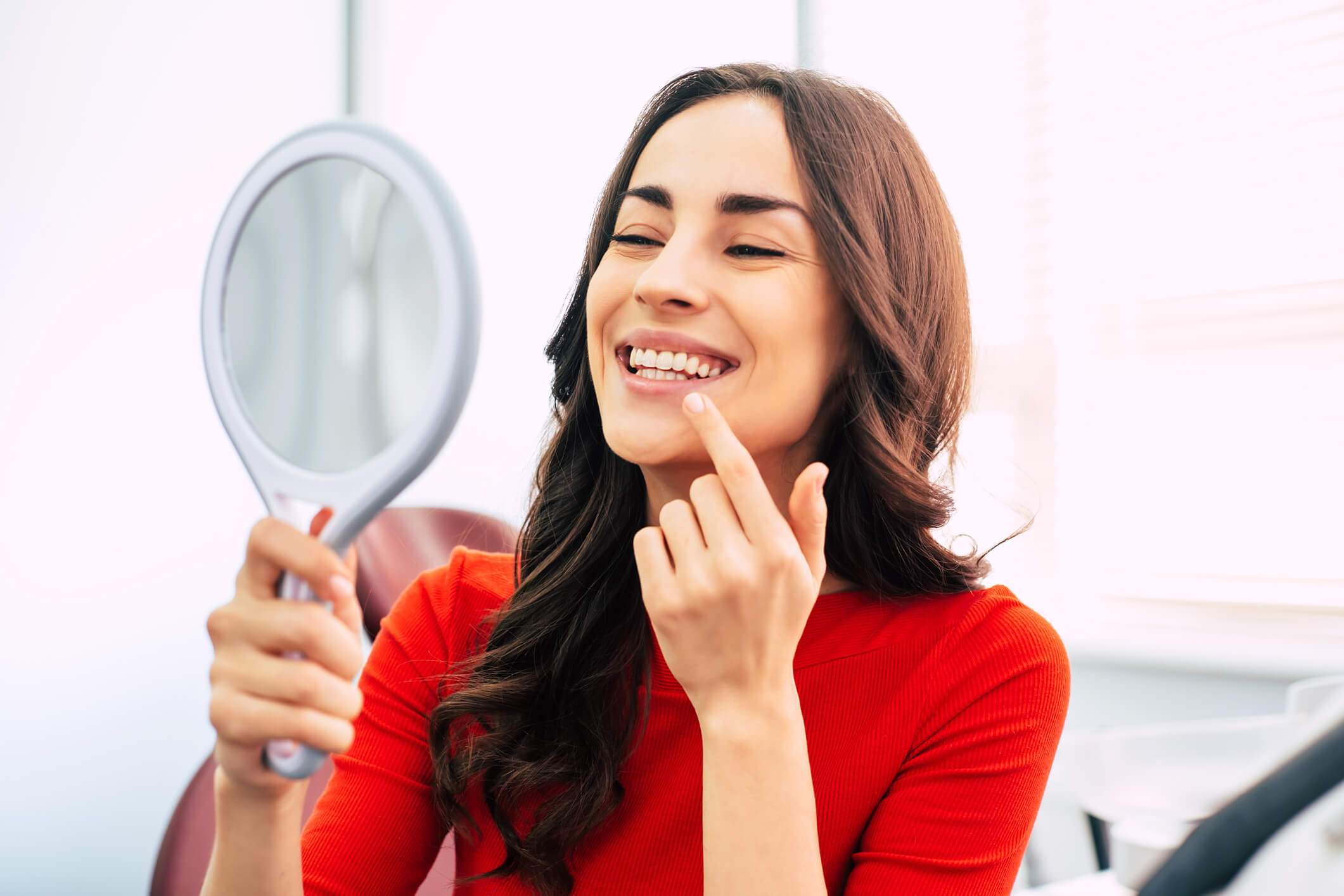 smiling woman looking in mirror