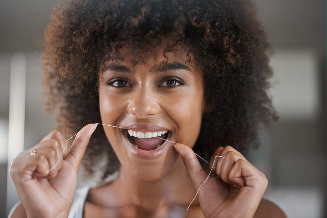 smiling woman flossing