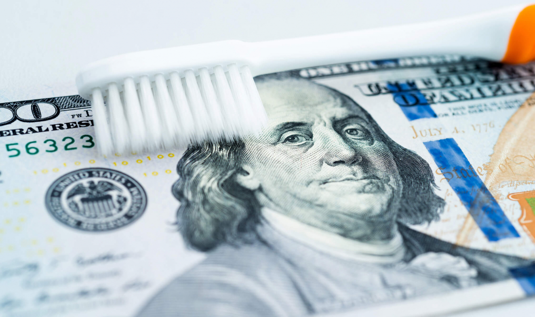 toothbrush and 100 dollar bill
