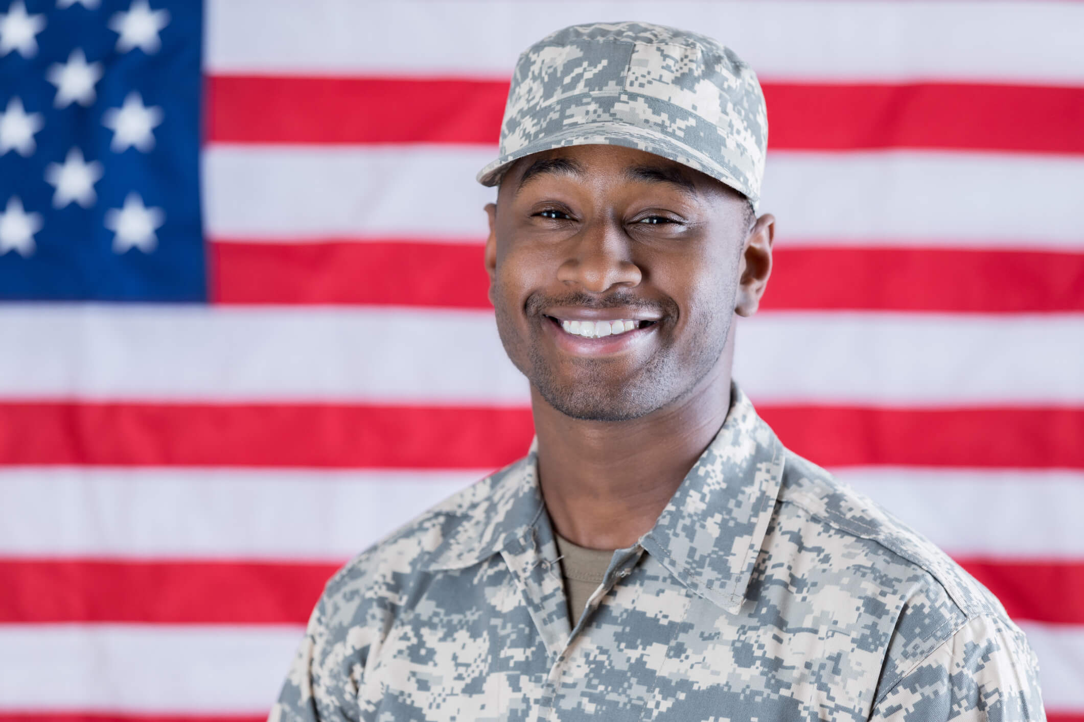 smiling veteran in front of american flag