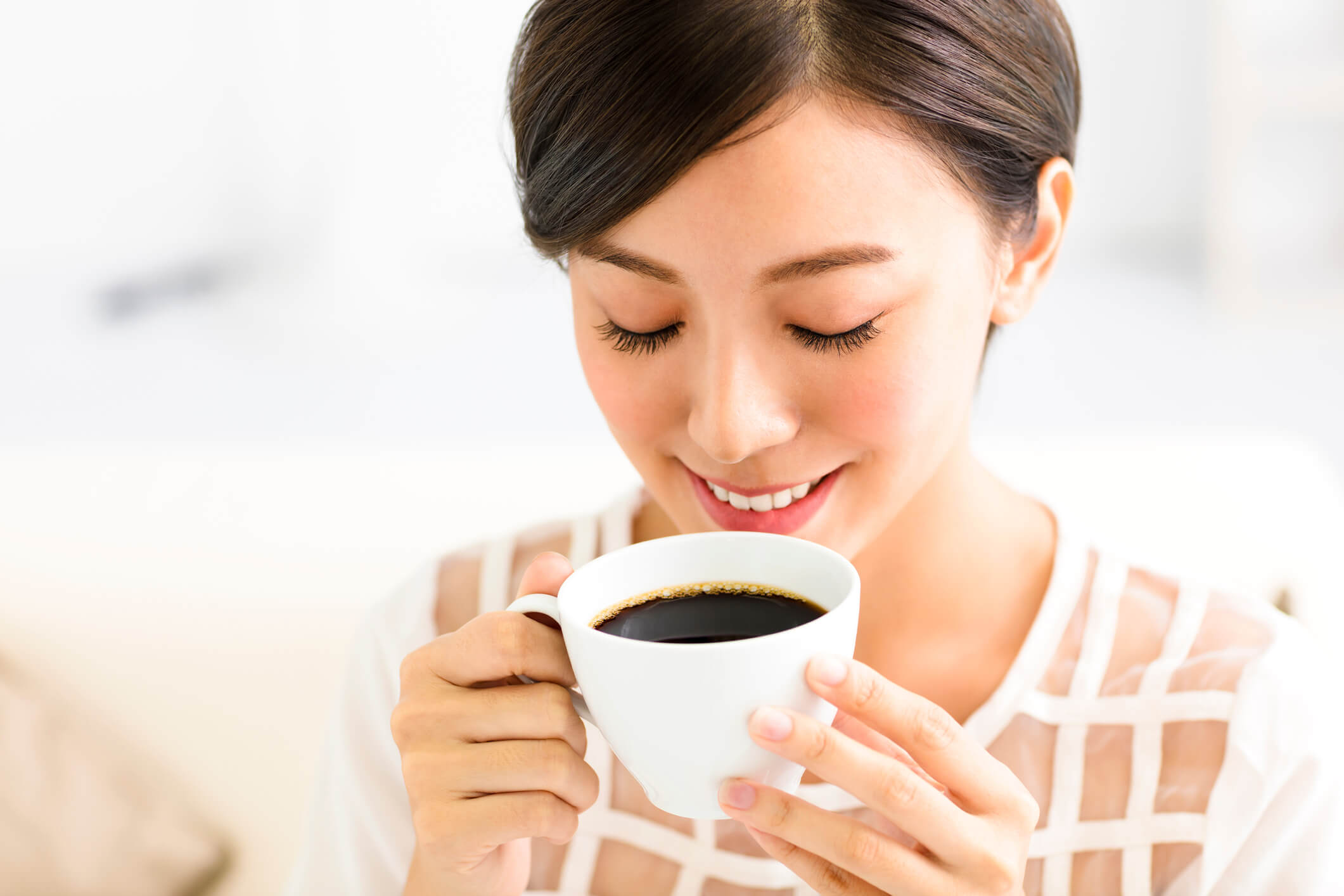smiling woman sipping tea