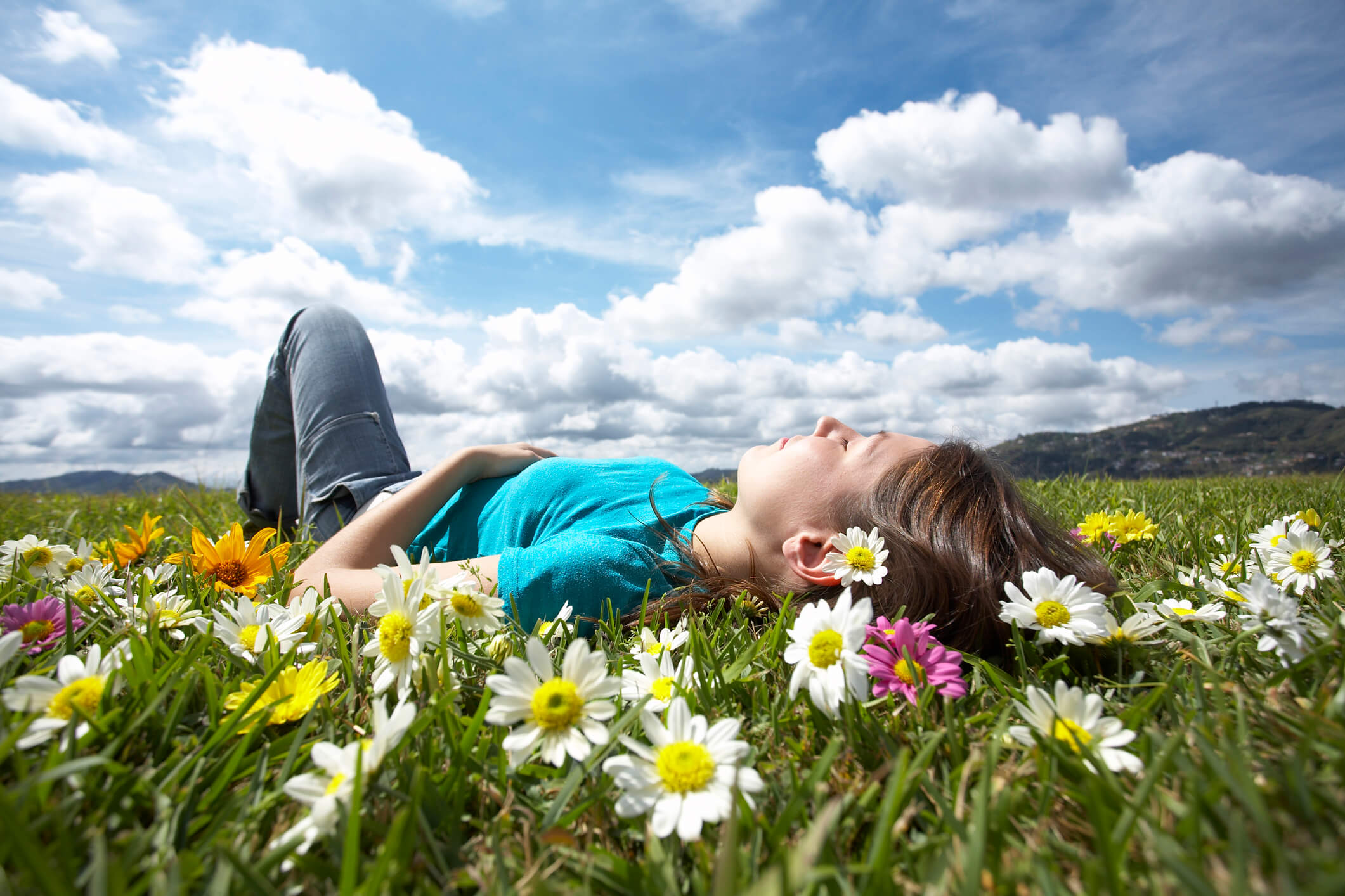 woman laying in grass with flowers