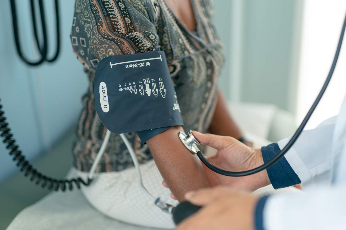 blood pressure cuff on woman arm