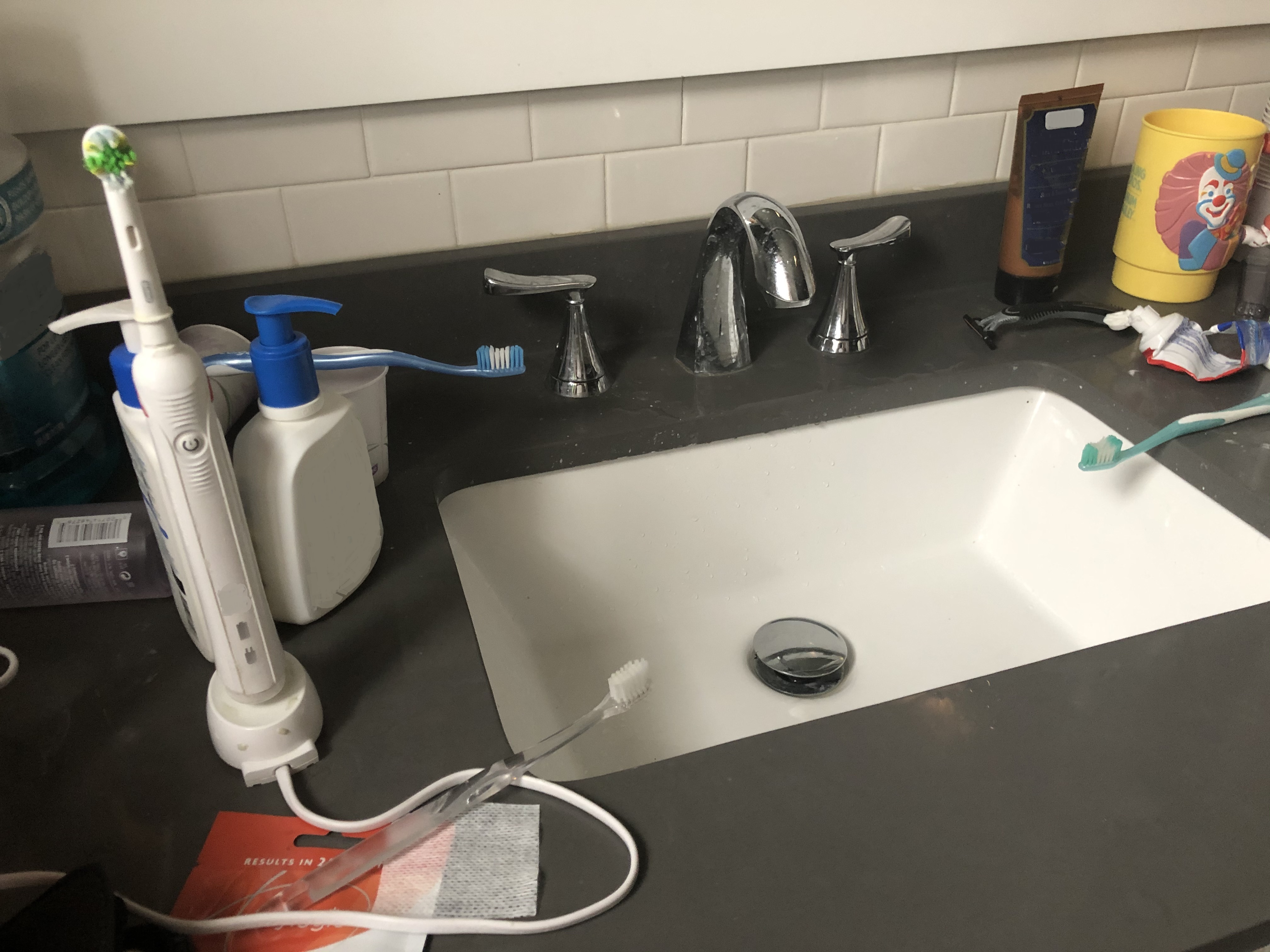sink with toothbrushes on it