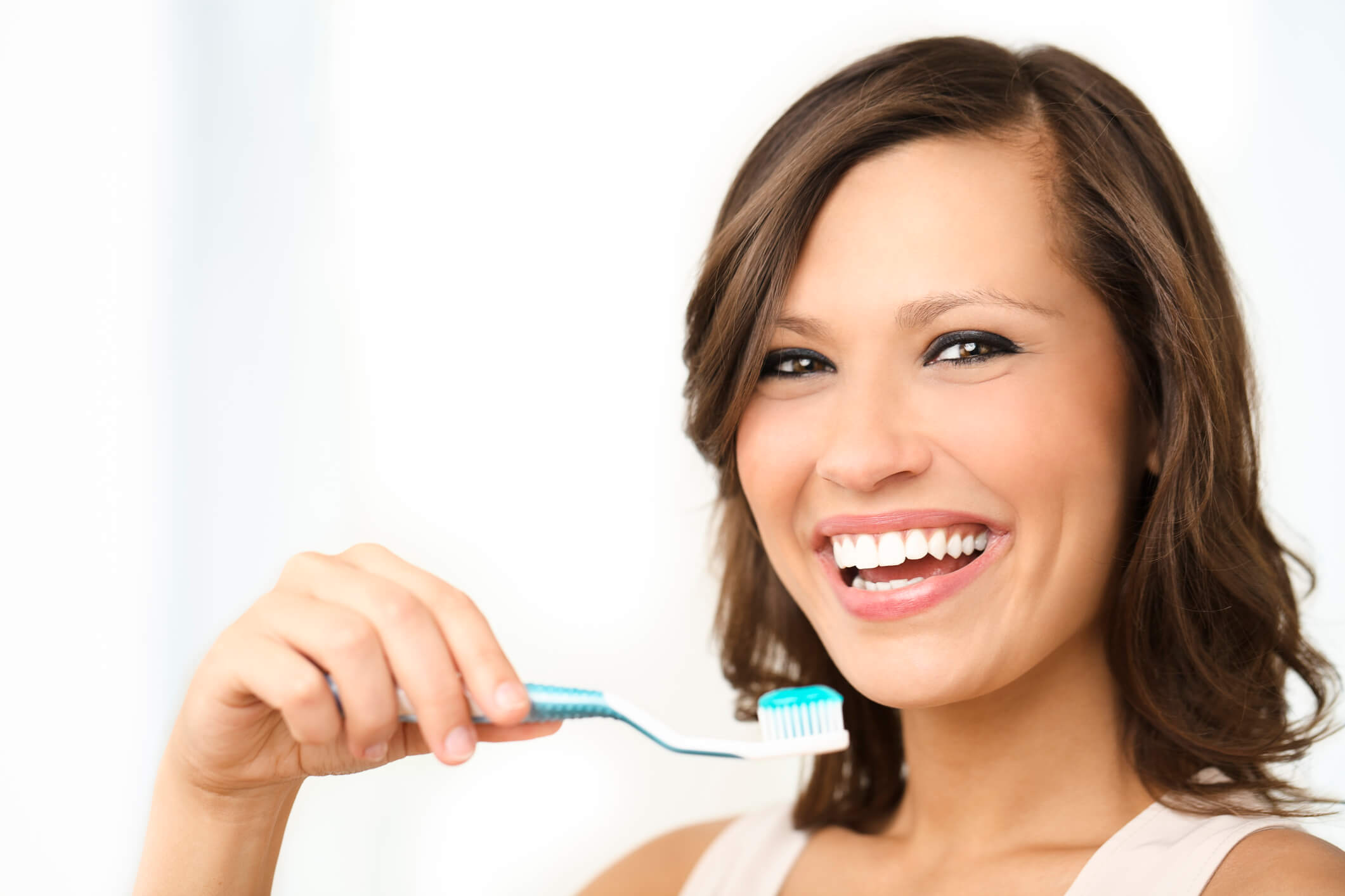 smiling woman about to brush teeth