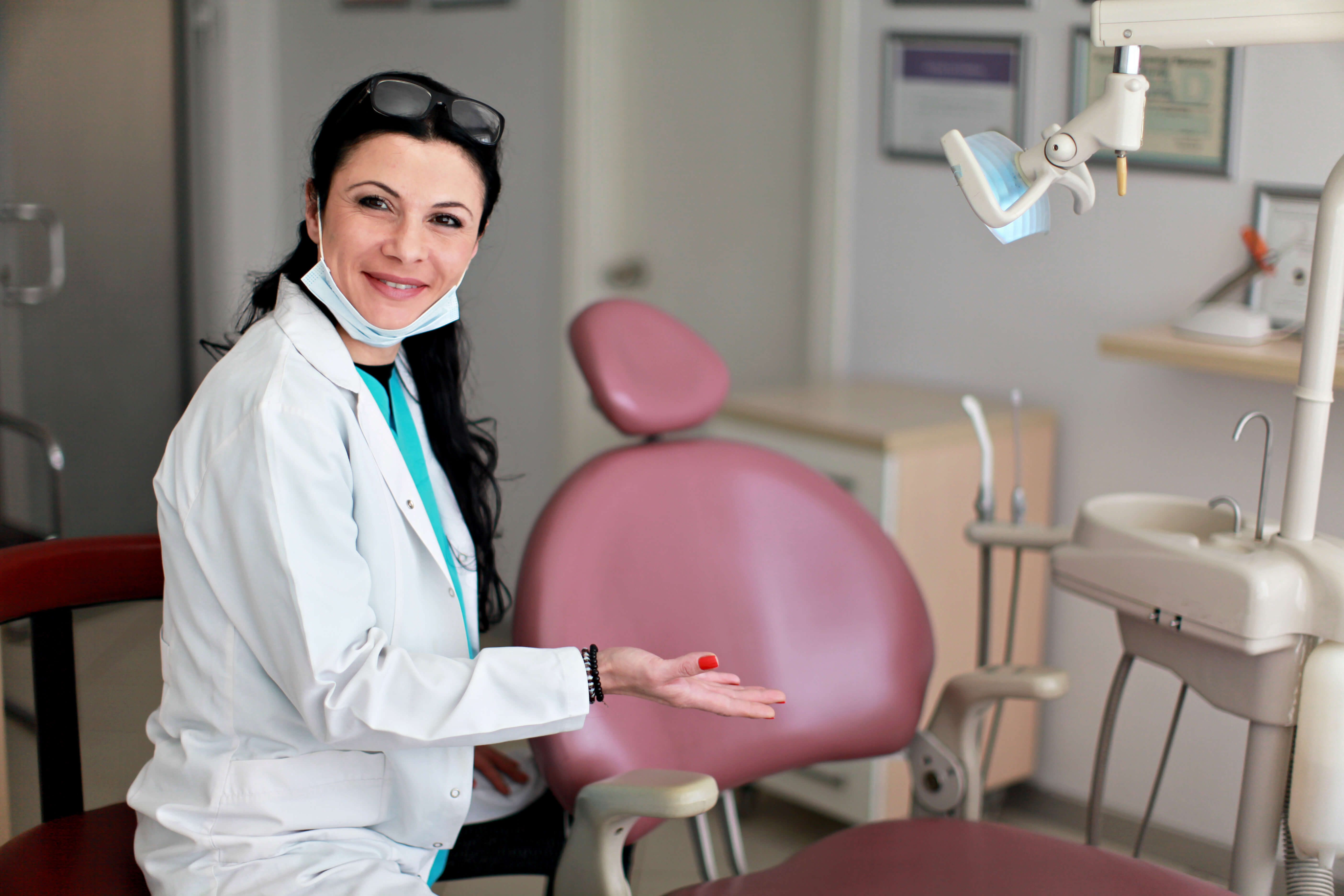 smiling woman in front of dental chair