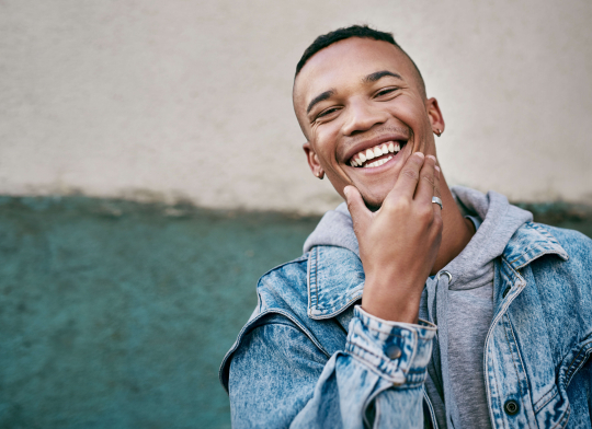 smiling man with hand on chin