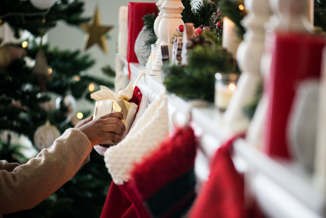 person filling christmas stocking