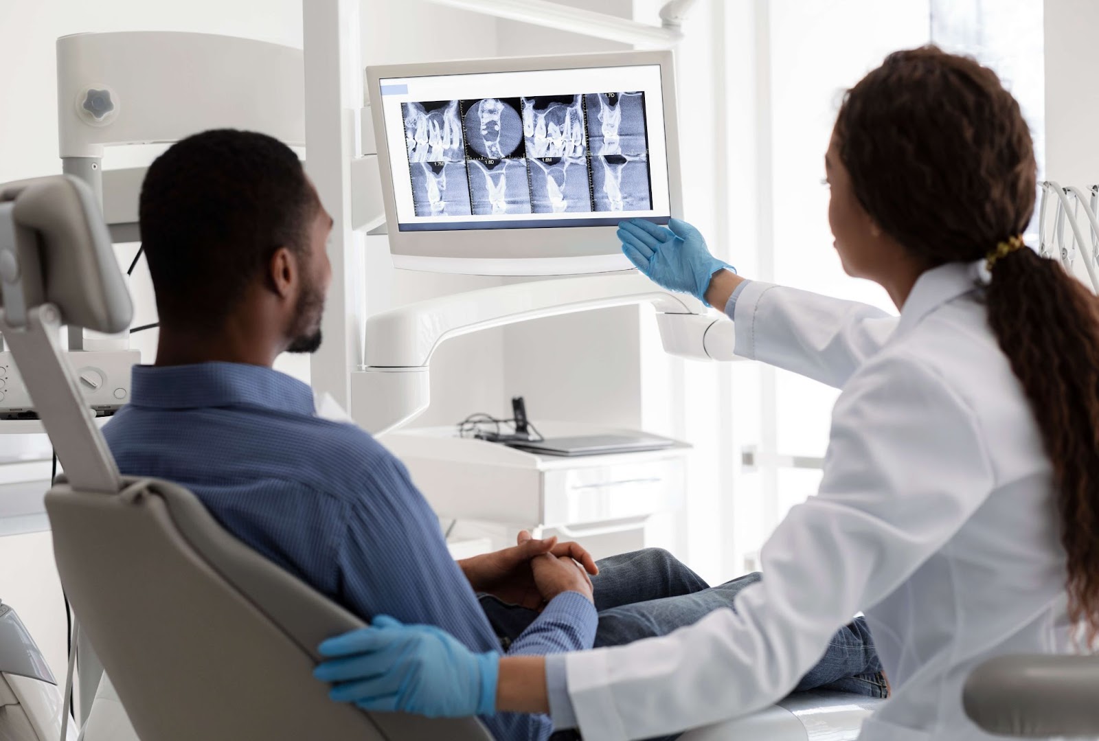 man and woman examining dental x-rays