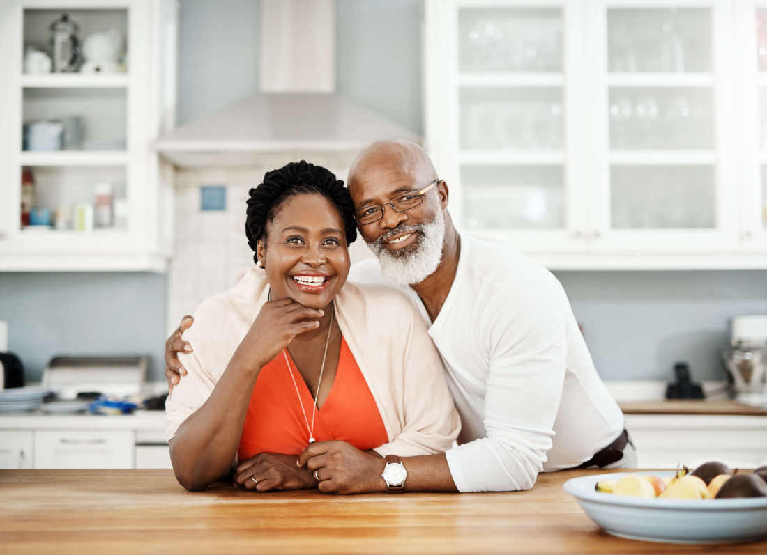 smiling senior man and woman hugging