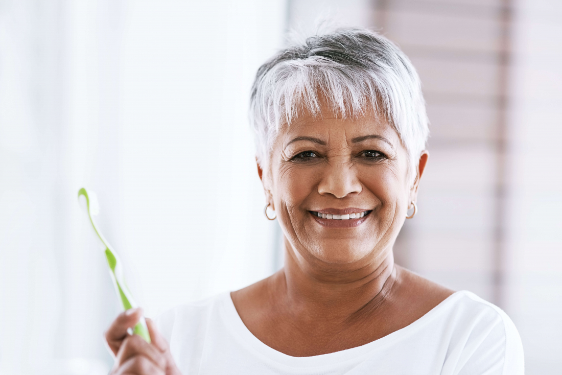 woman cleaning dentures