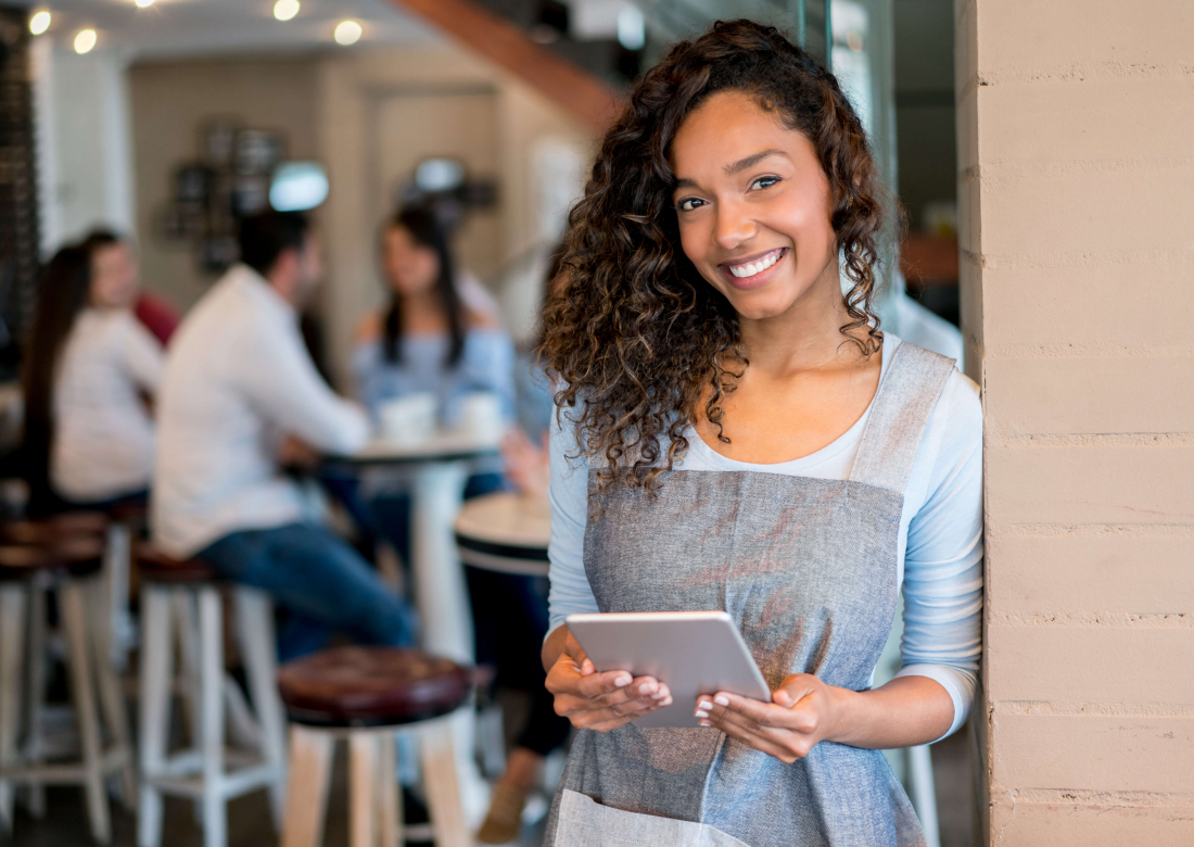 smiling woman holding device