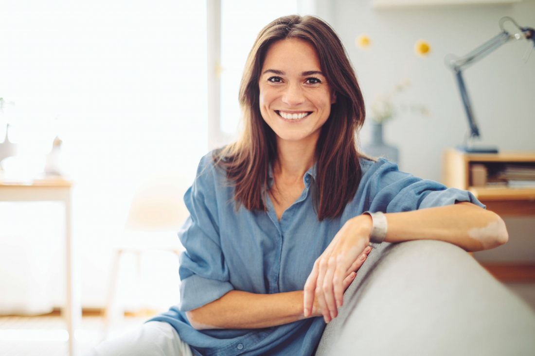 Smiling woman sitting on couch