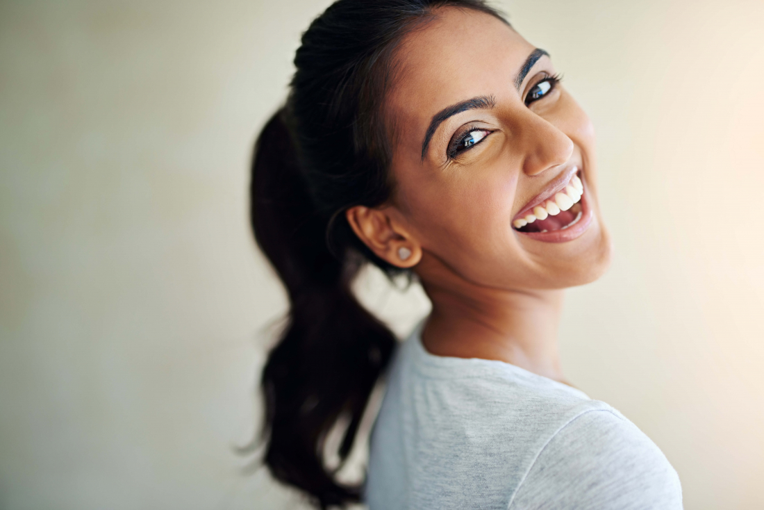 smiling woman looking over shoulder