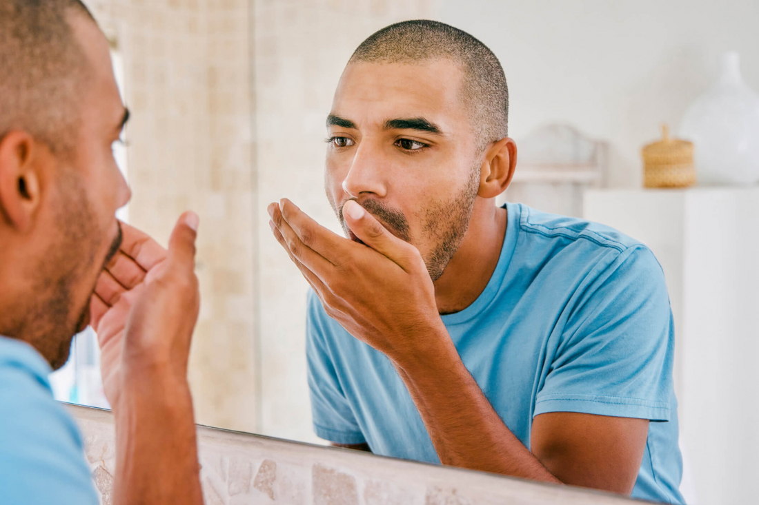 photo of man with bad breath affected by tooth decay