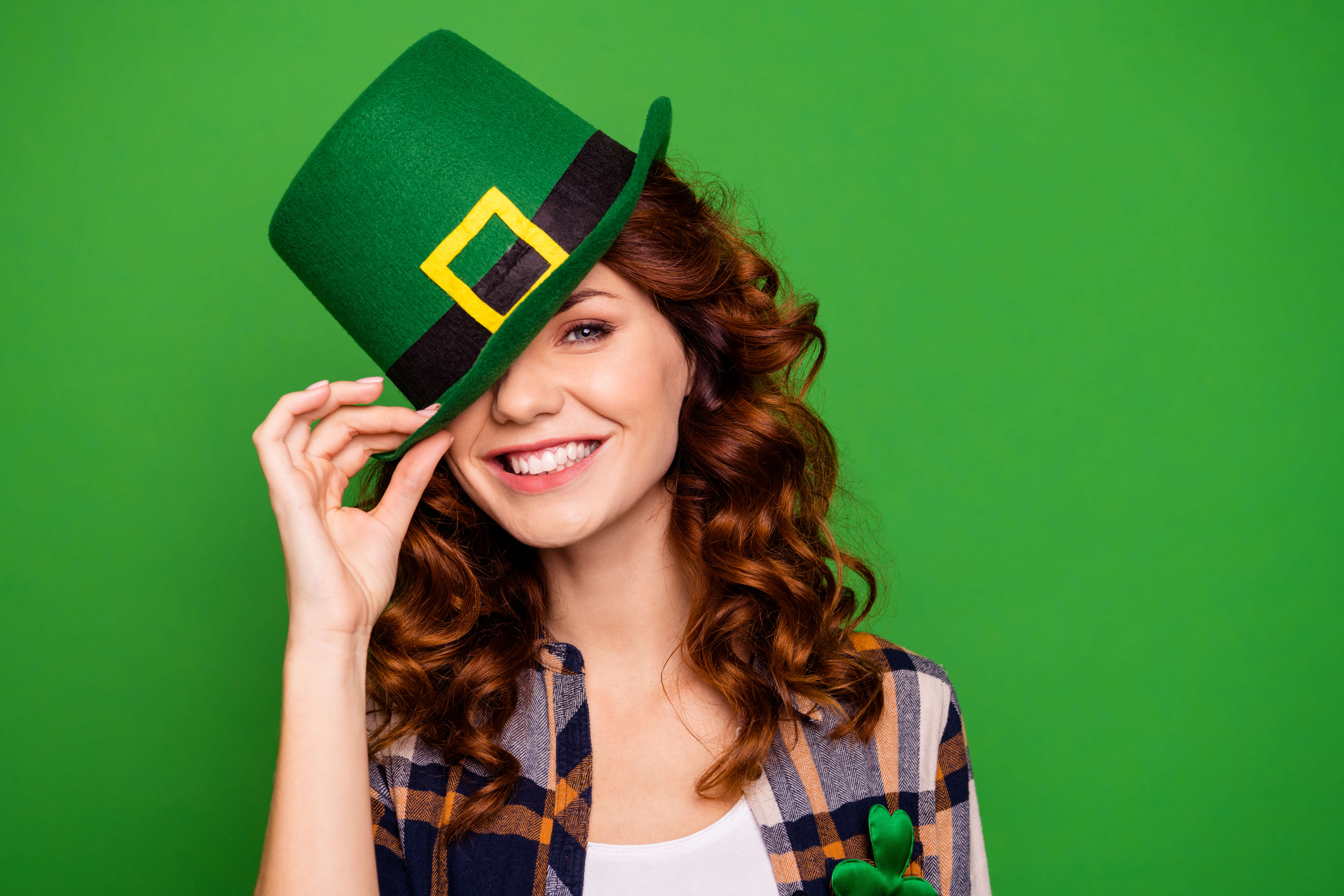 woman wearing green hat smiling