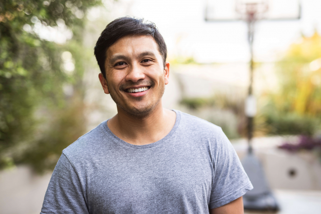 man with gray tshirt smiling