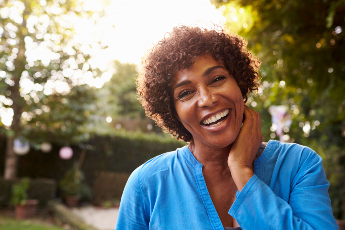 woman wearing blue shirt smiling